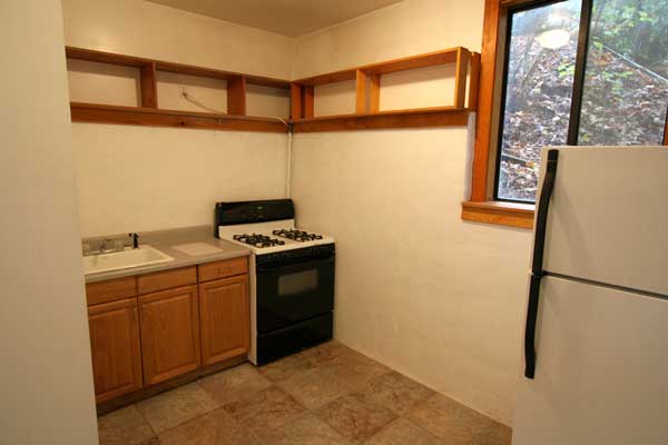 Kitchen with gas stove and refrigerator included.