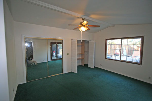 The Master bedroom is in the rear of the house with a sliding glass door onto the covered porch.  It includes two huge closets.