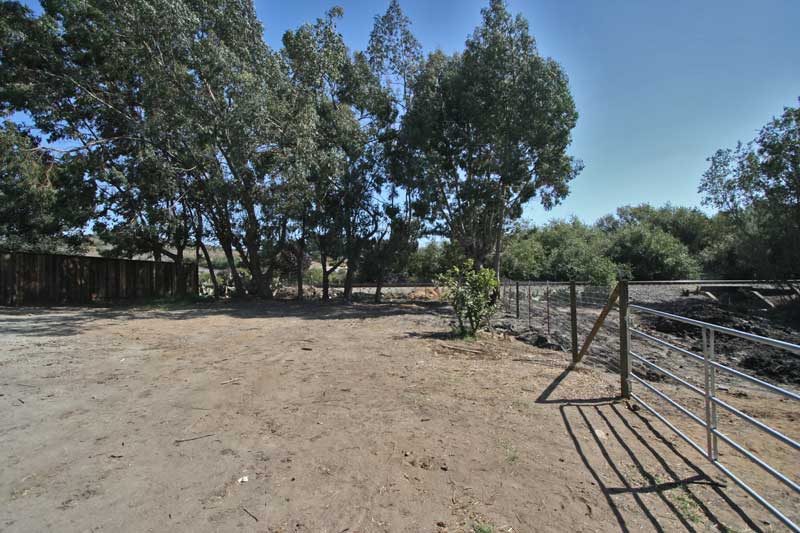 There is a huge parking area behind the house and a shady back yard, all fenced in. 
