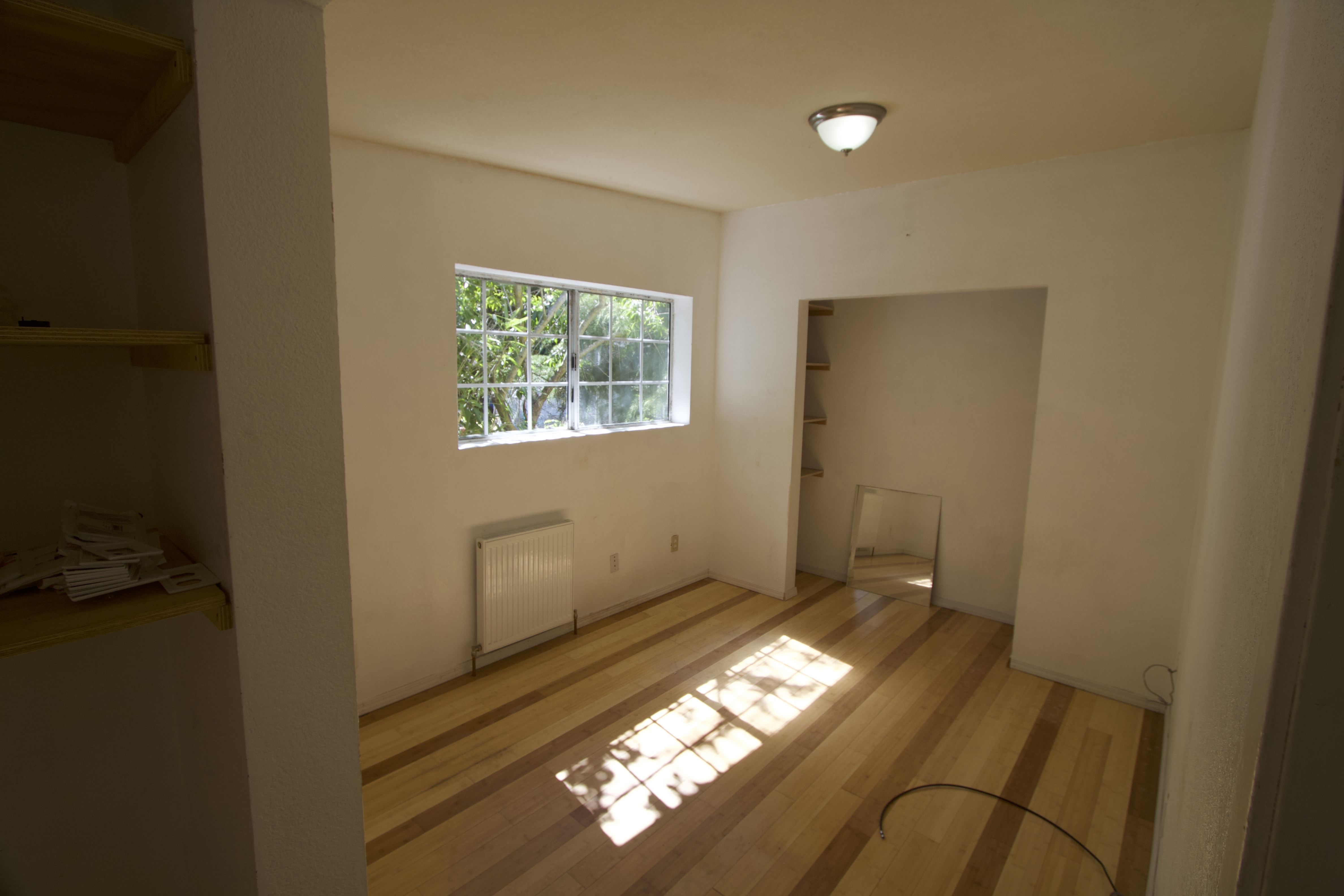 Bedroom with bamboo flooring.