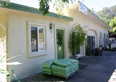 Front of the Bays building with large parking area.
