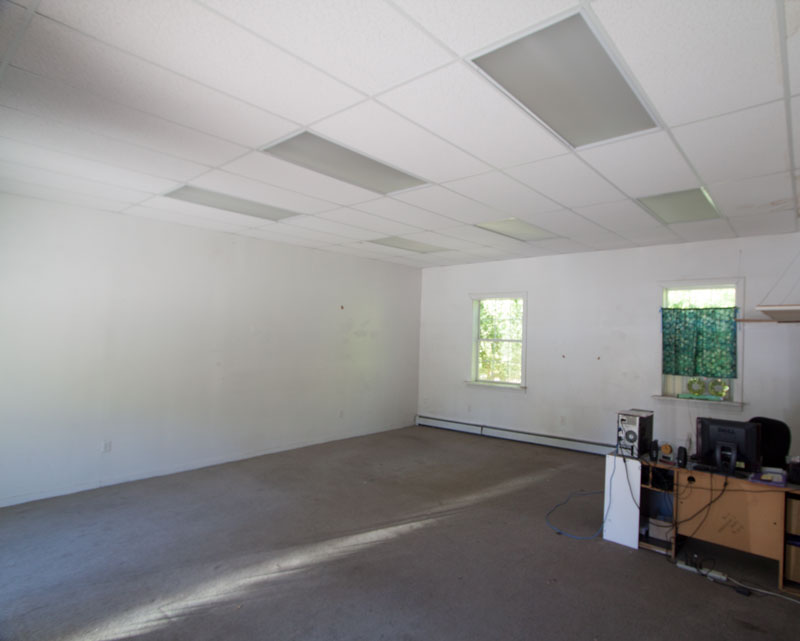 Bay 5 interior finished as an office — carpeted floor, drop ceiling, and natural light.